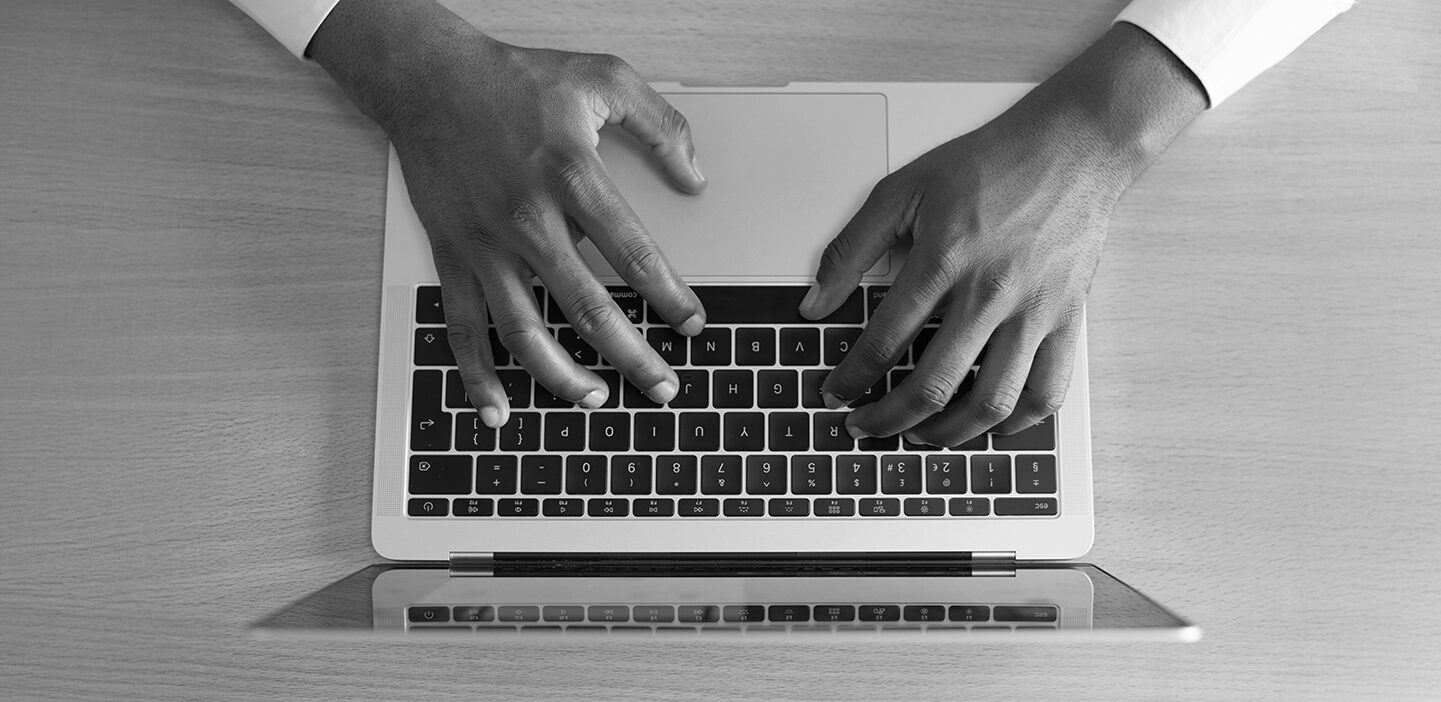Image of hands on a desktop keyboard
