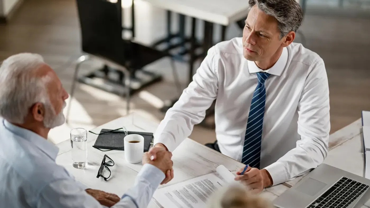 A man shaking another mans hand agreeing on some sort of business